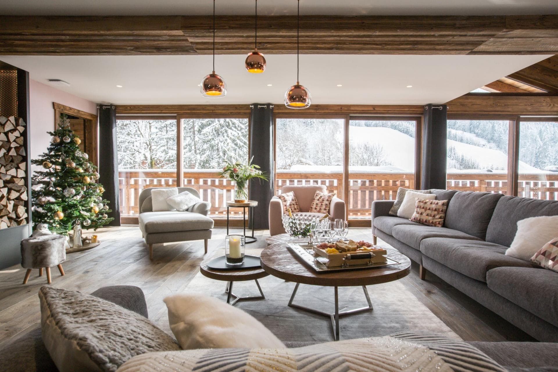 Living area with floor-to-ceiling windows and snowy mountain views