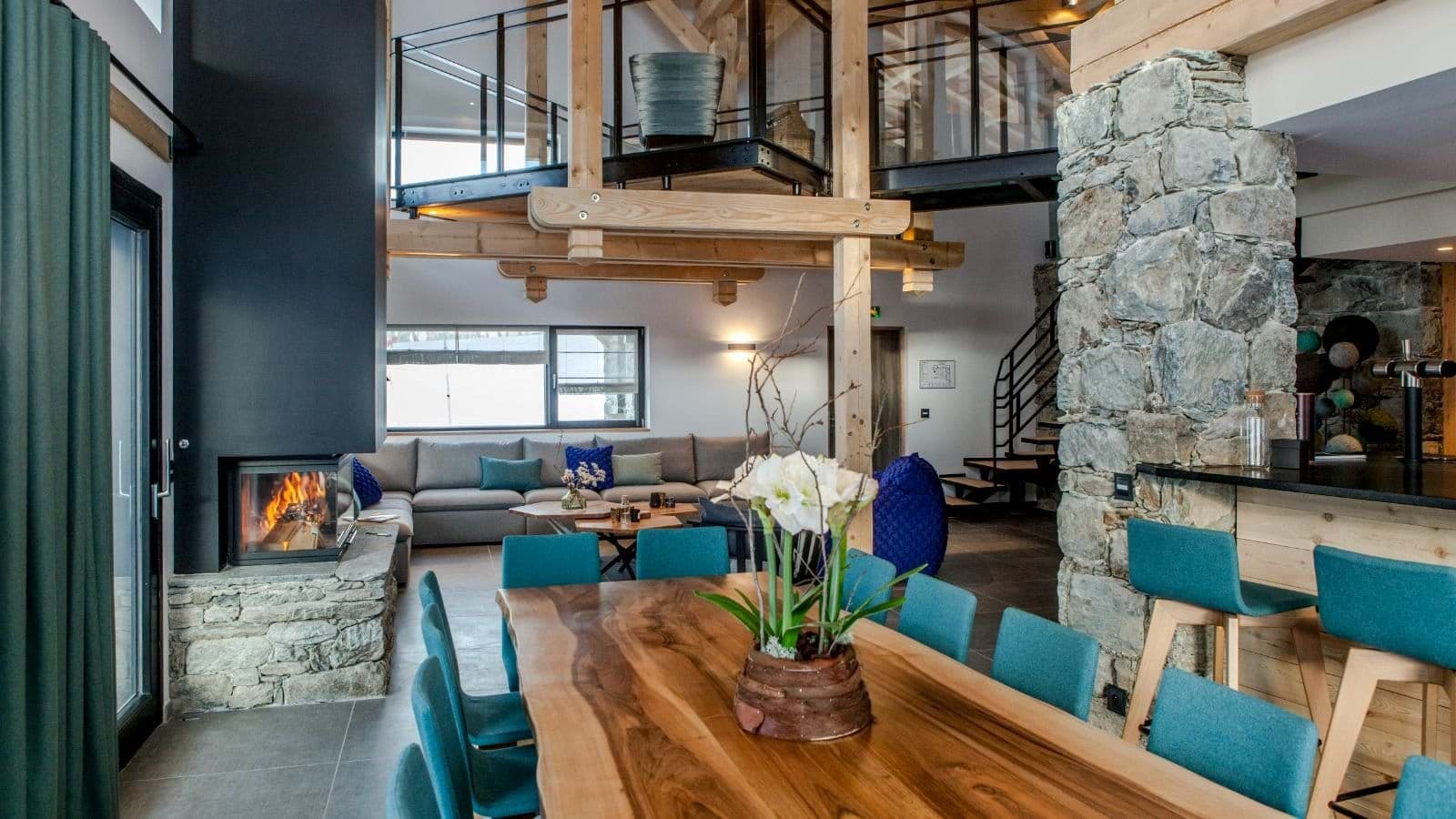 Open-plan living area with wood-burning fireplace and mezzanine balcony