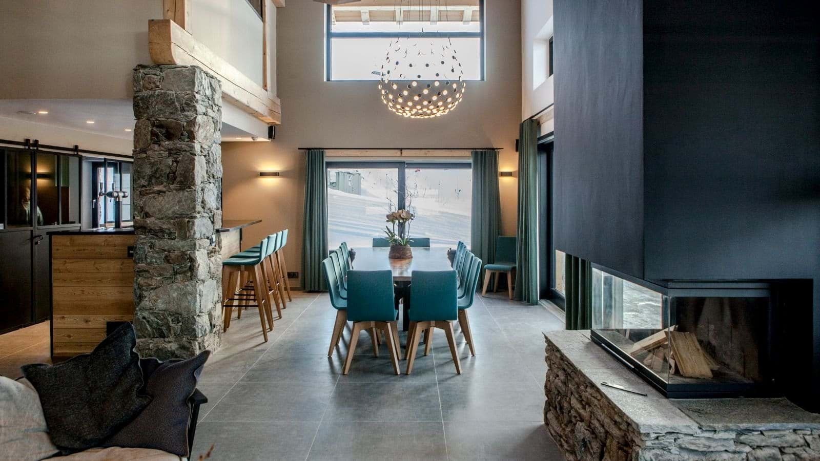 Open-plan dining area for 10 with three-sided fireplace and breakfast bar