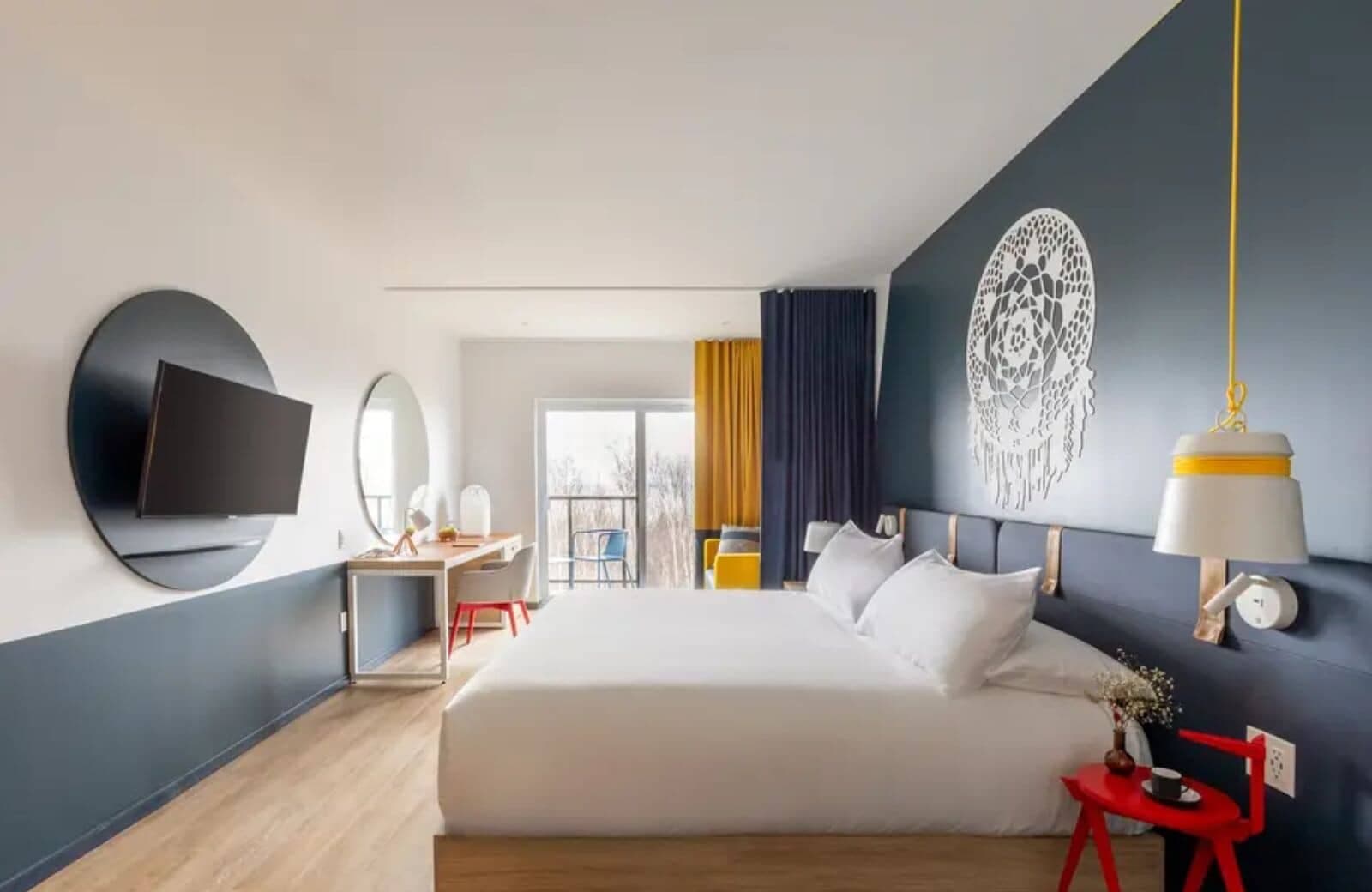 Primary bedroom with king bed, dedicated workspace, and private balcony