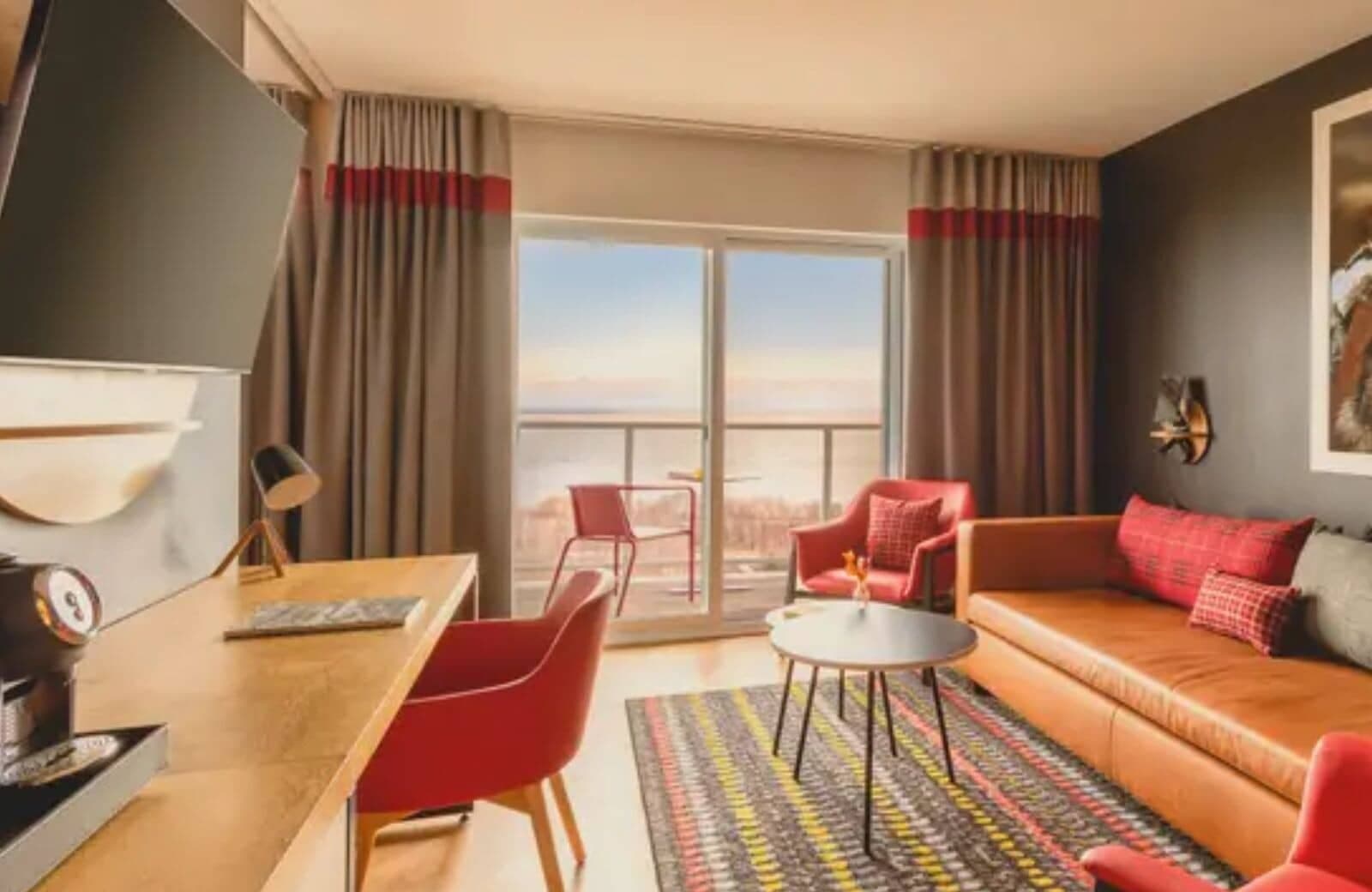 Living area with dedicated workspace and private balcony overlooking the water