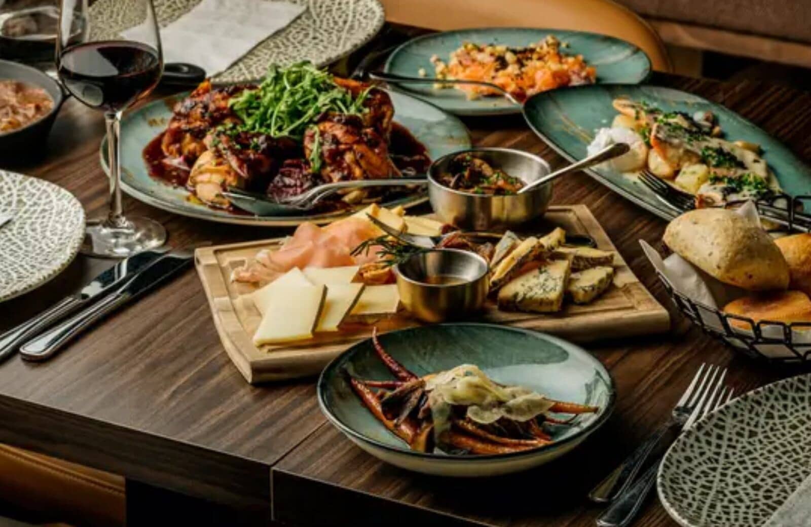 Dining table set for family-style service with curated catering options