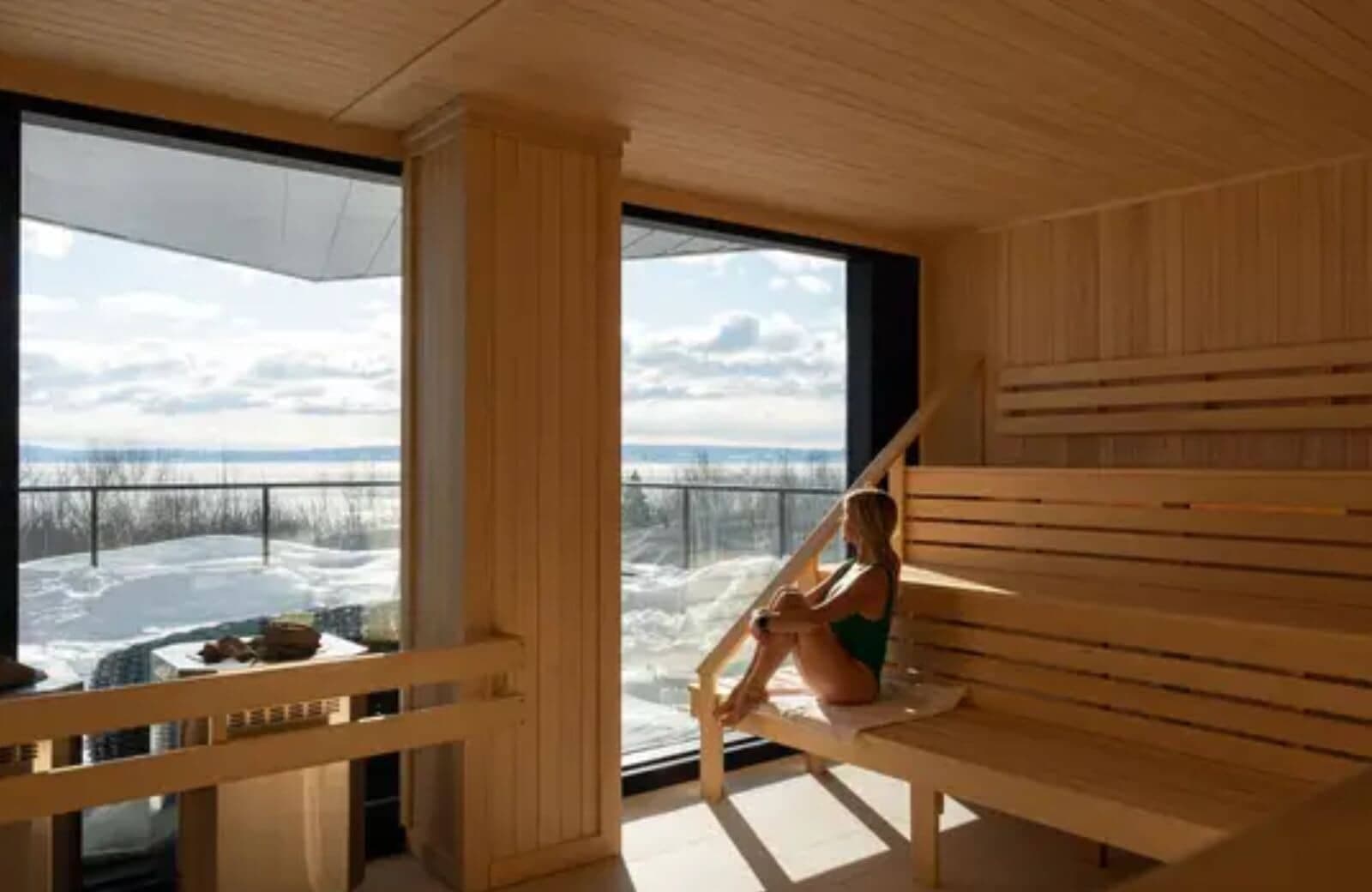 Cedar sauna with tiered seating and floor-to-ceiling lake views