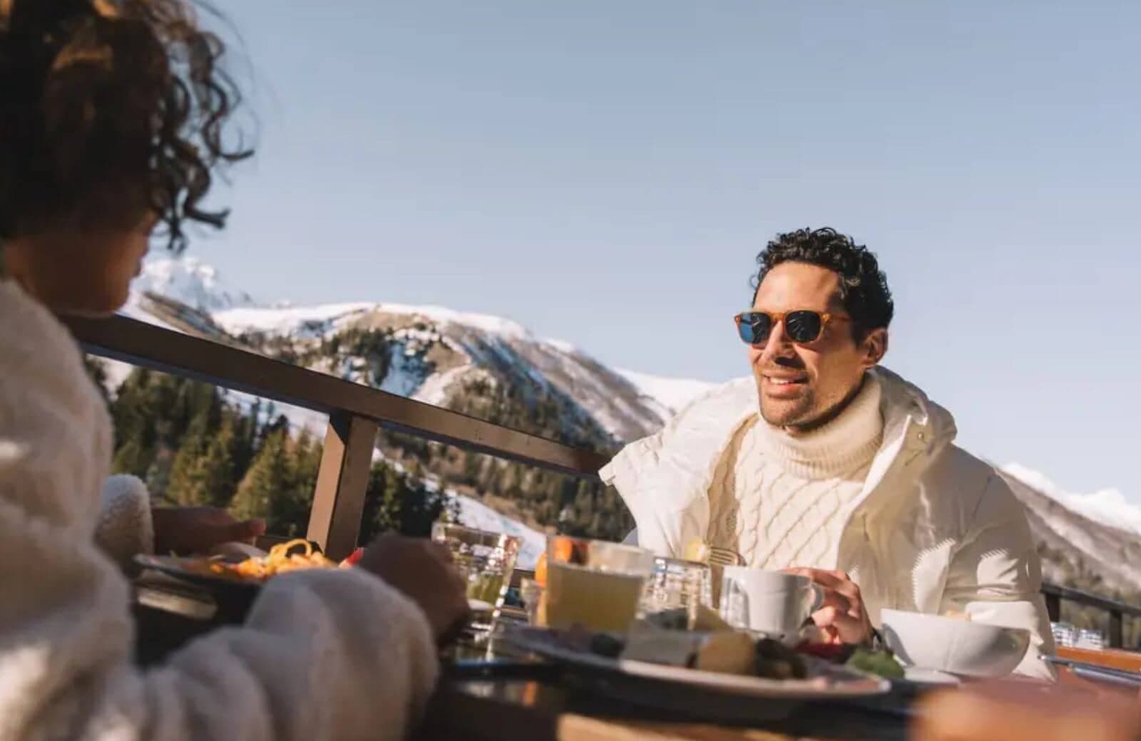Private balcony dining area with mountain and forest views