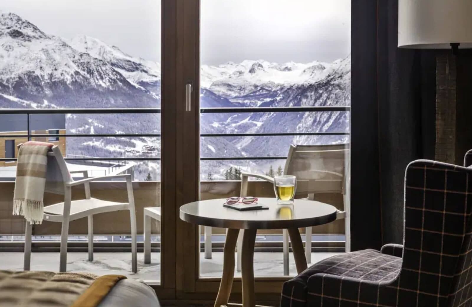 Private balcony with seating and panoramic Alps views