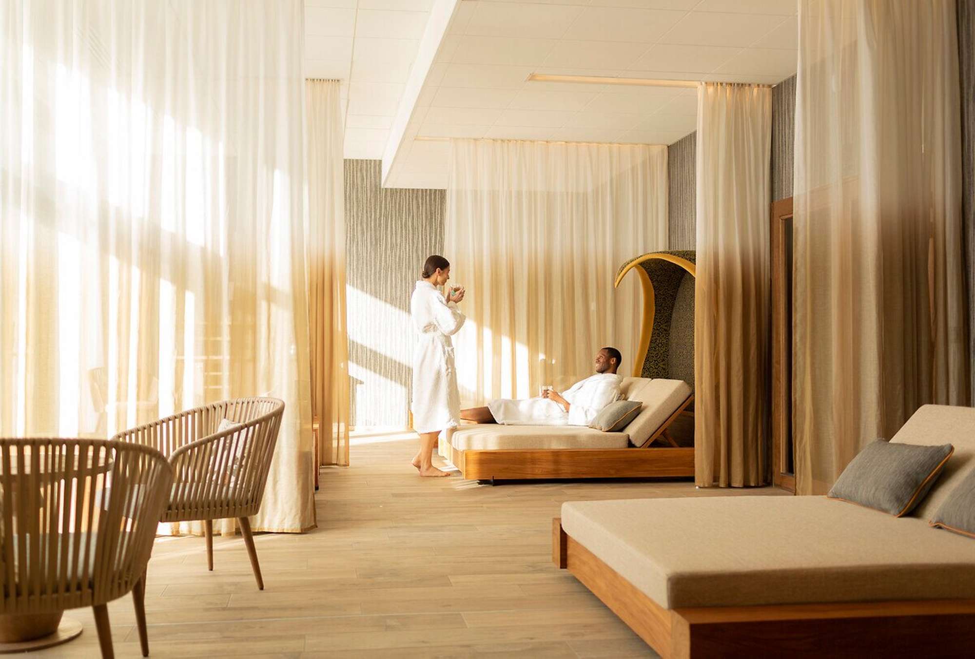 Spa relaxation lounge with daybeds and semi-private curtained bays