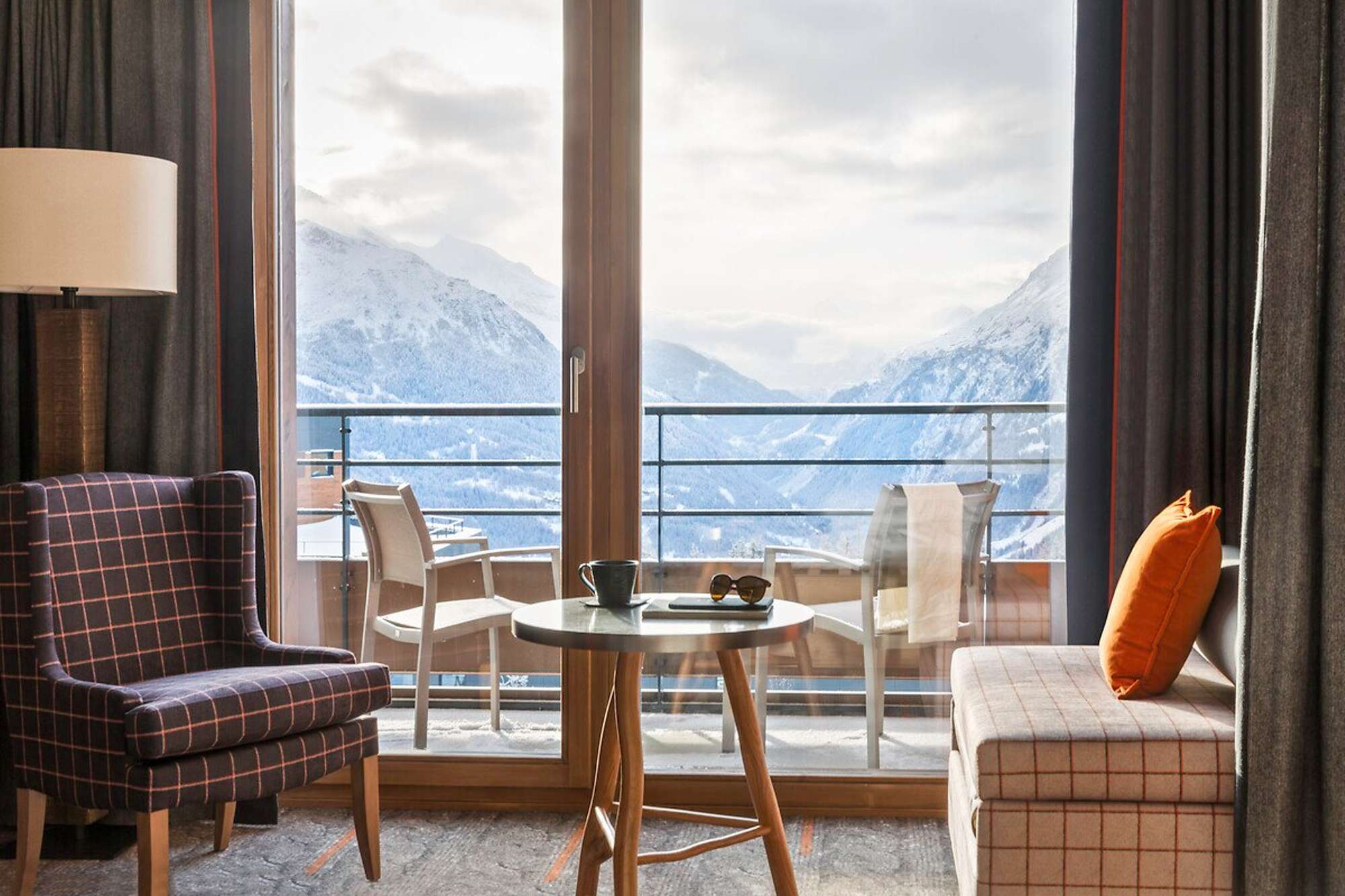 Seating area with mountain views and private balcony access