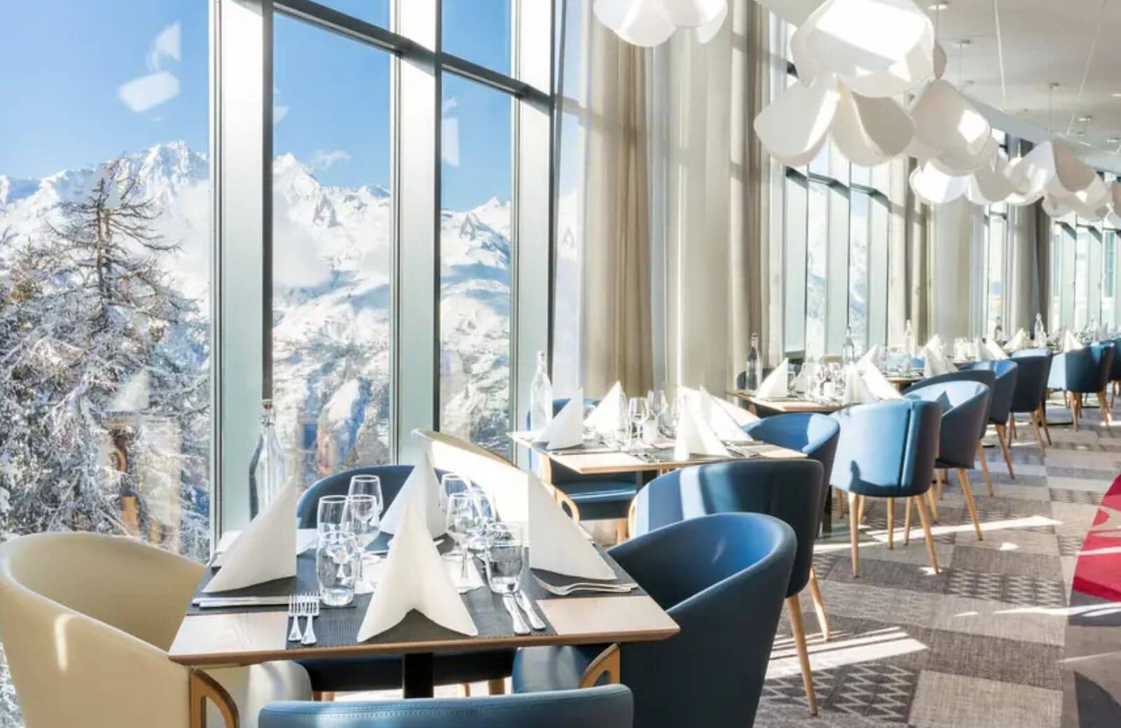 Dining room with floor-to-ceiling windows and panoramic mountain views