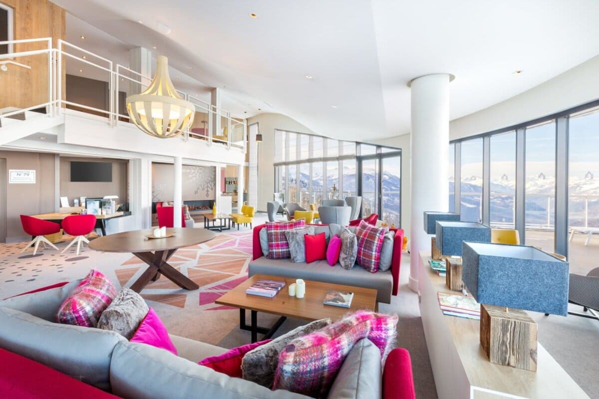 Open-plan living area with floor-to-ceiling windows and panoramic mountain views