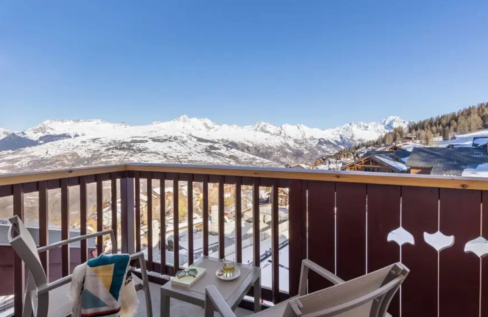 Private balcony with seating for two and panoramic Alpine views