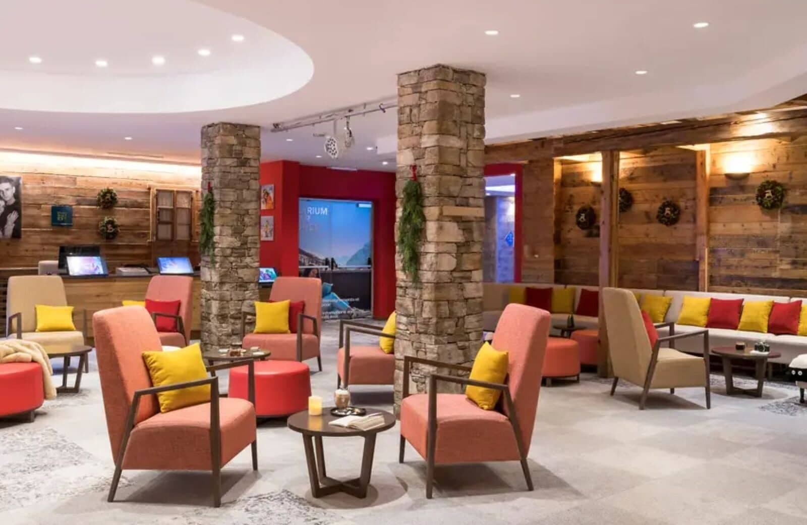 Lobby lounge with stone pillars and group seating near reception desk
