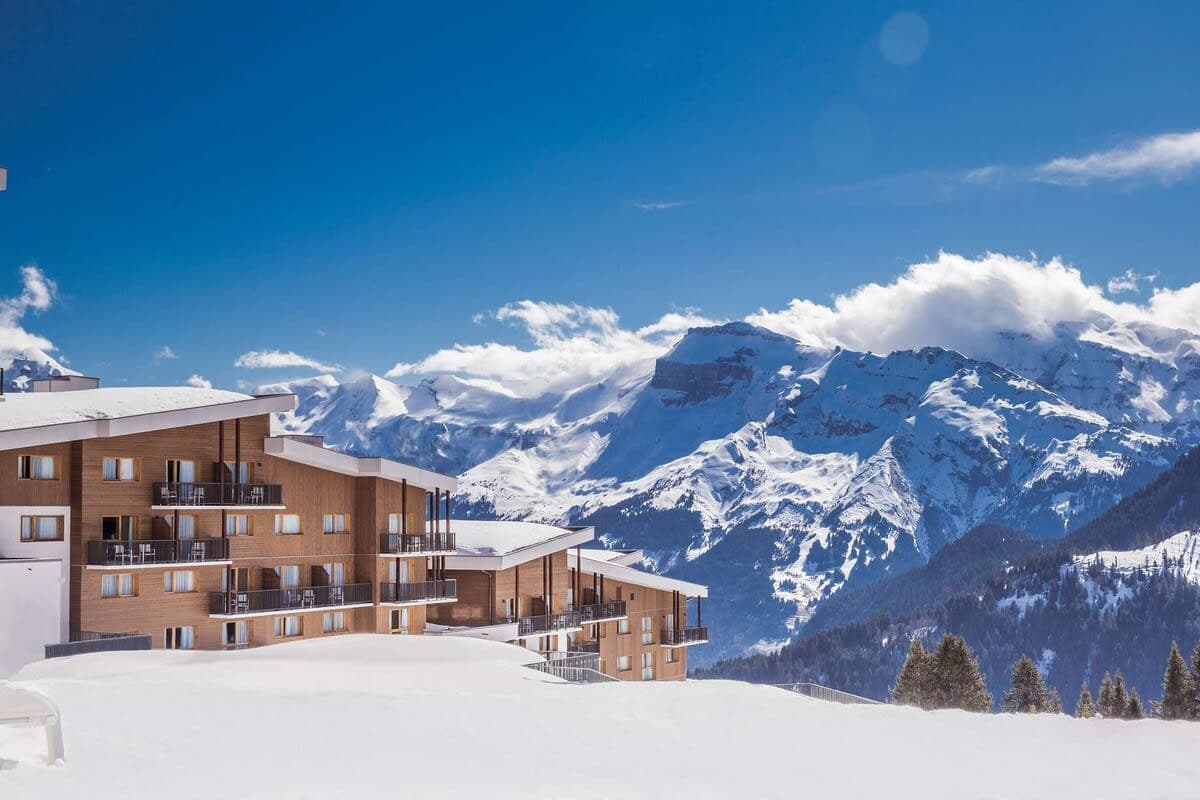 Ski-in/ski-out chalet exterior with private balconies and mountain range views