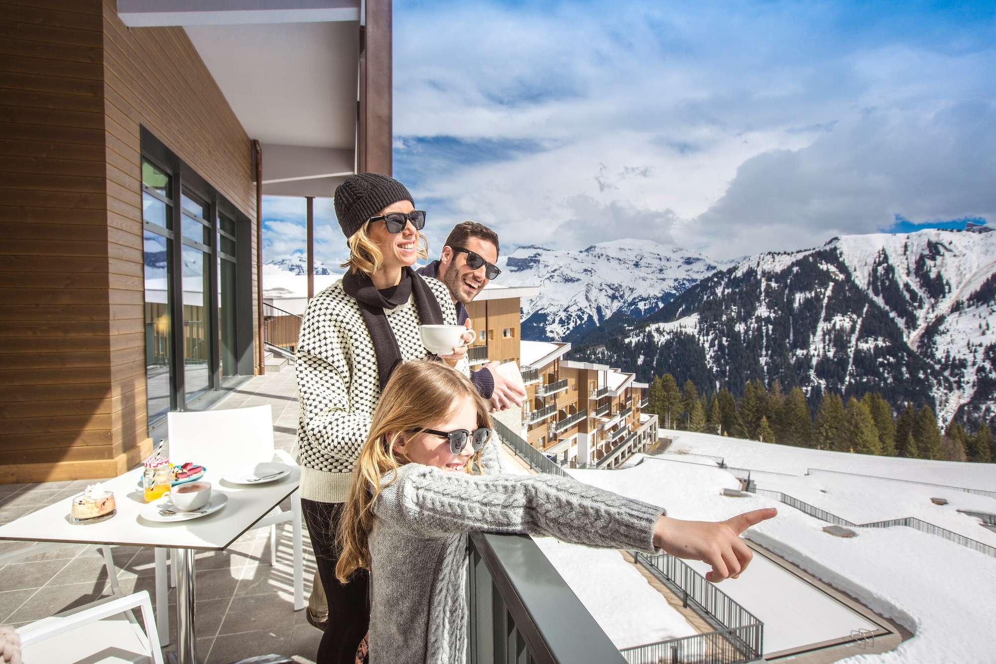Private balcony with cafe seating and panoramic alpine views
