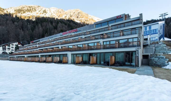 Ski-in/ski-out hotel exterior with private balconies and mountain views