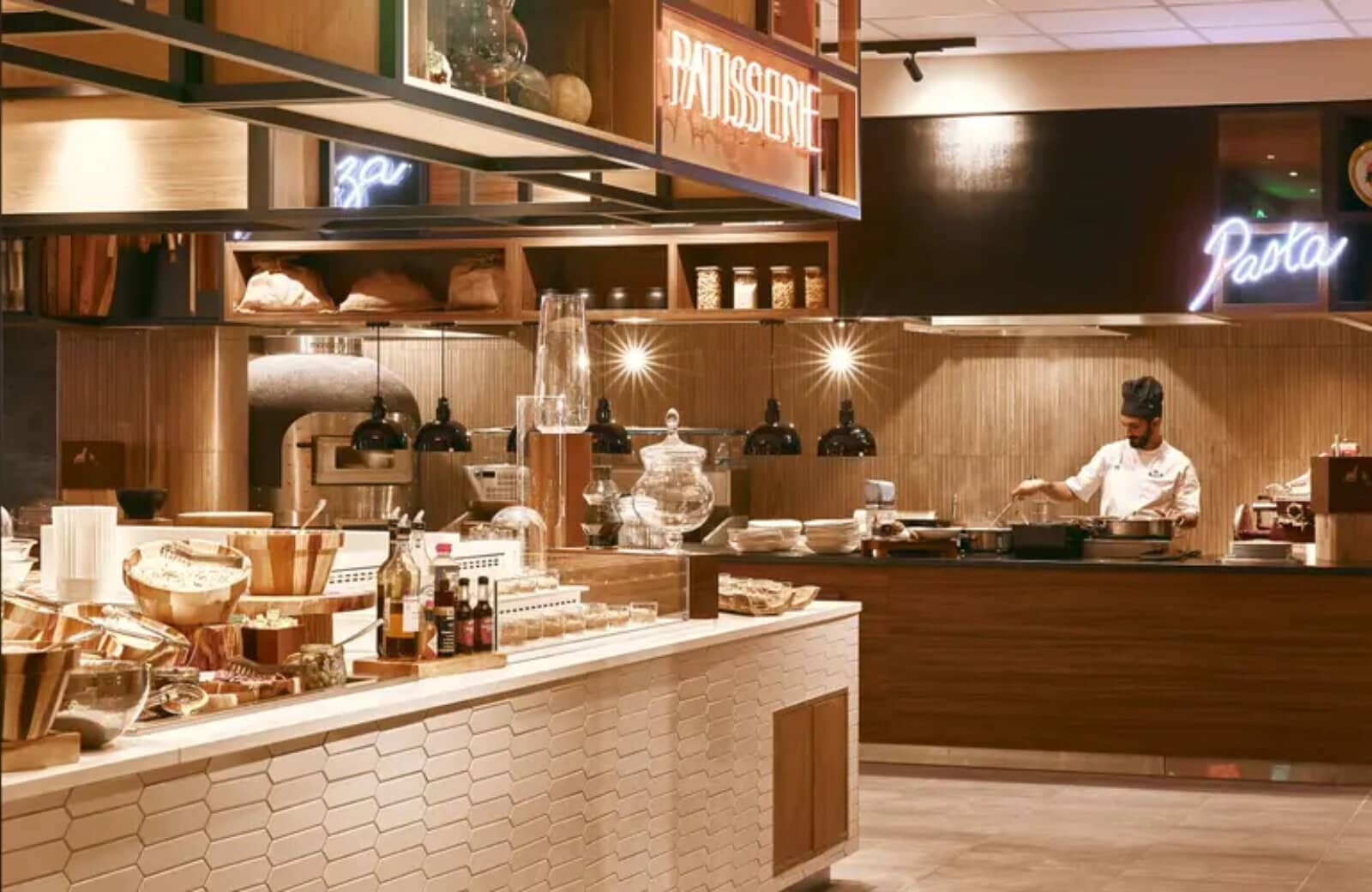 Open kitchen area with wood-fired pizza oven and pasta station