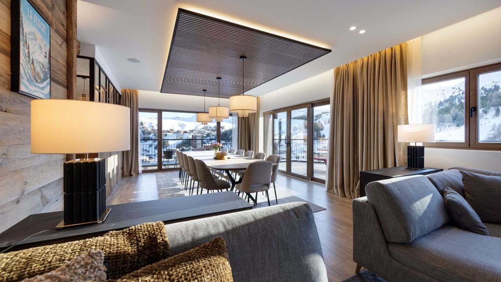Dining area seats 12 with floor-to-ceiling mountain views
