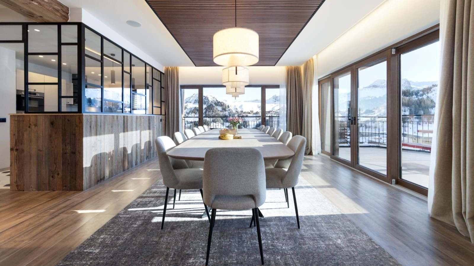 Dining table seats 12 with floor-to-ceiling mountain views