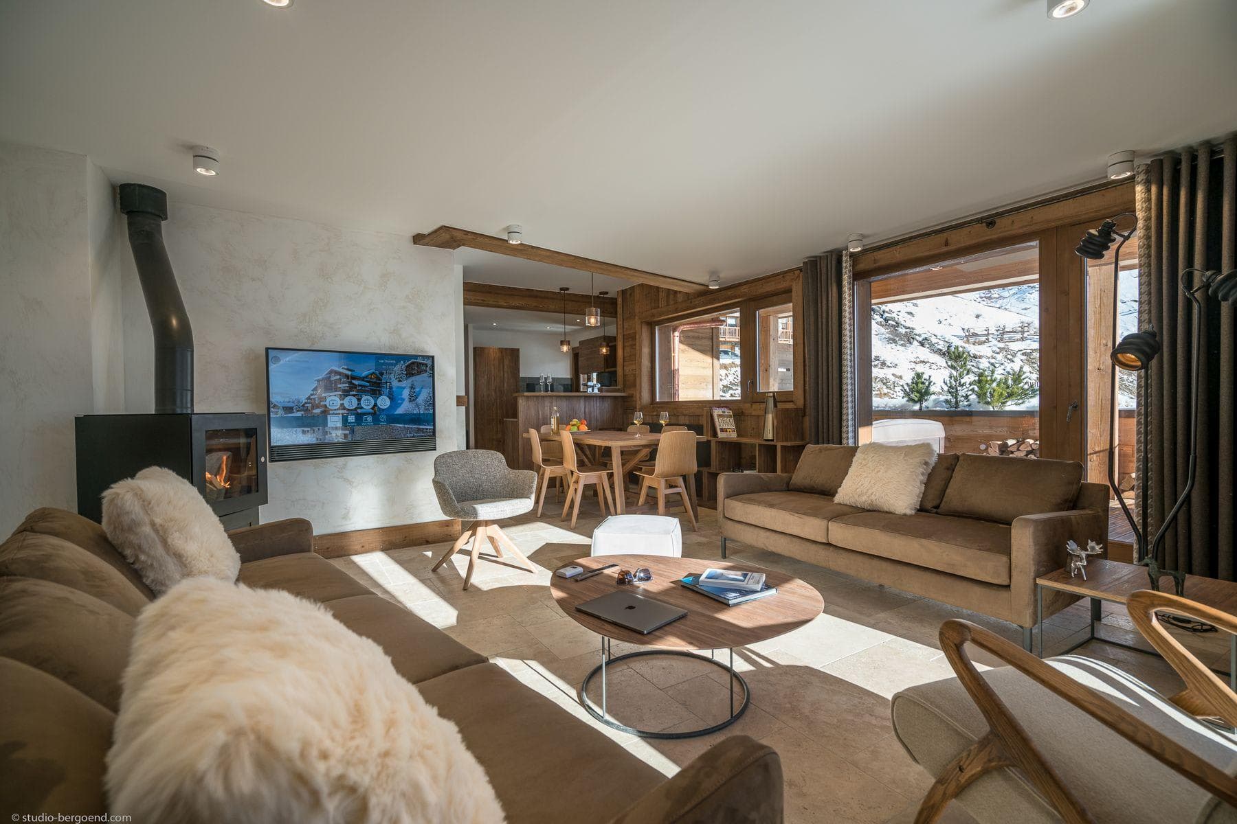 Living area with wood-burning stove and mountain views