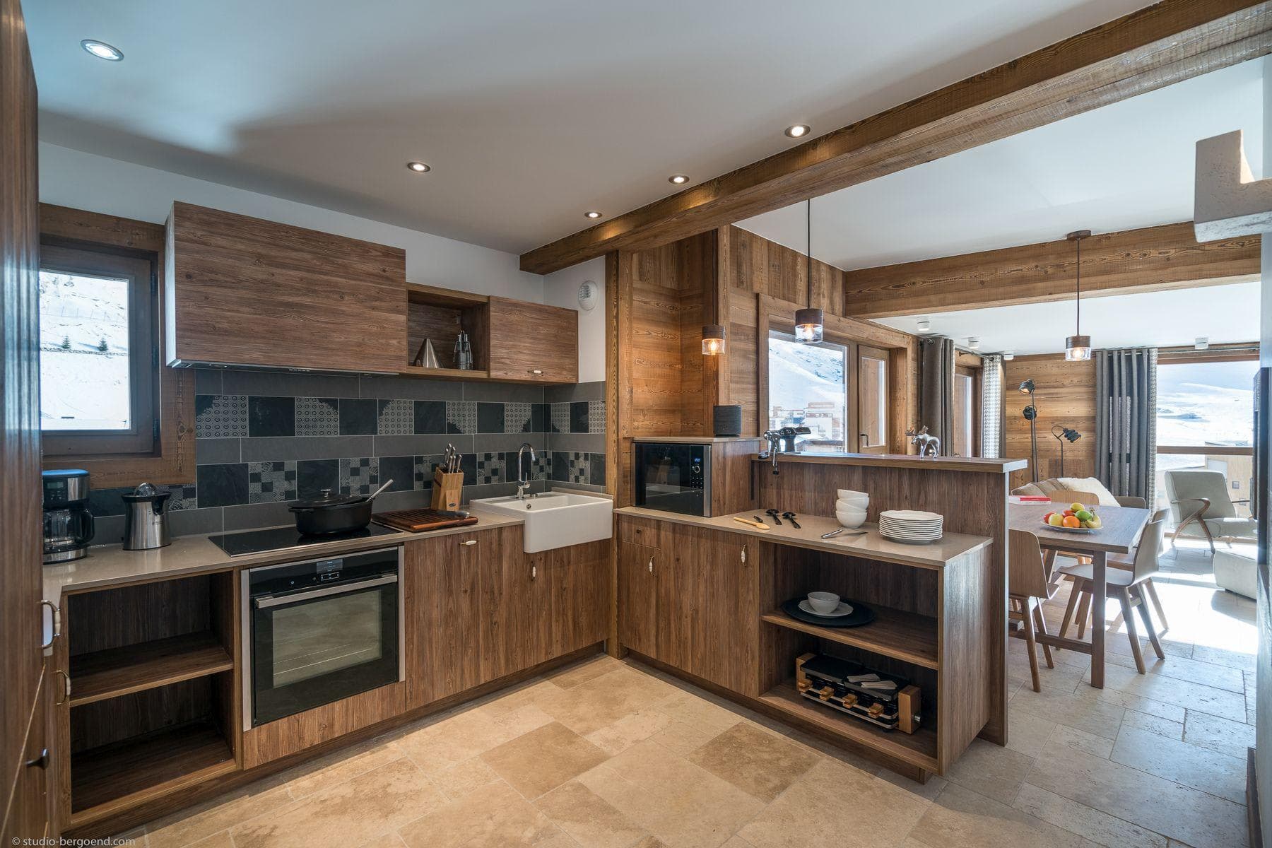 Kitchen with induction cooktop, farmhouse sink, and raclette grill
