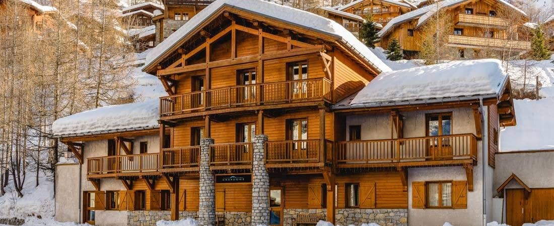 Ski-in/ski-out chalet with multi-level timber balconies and mountain views