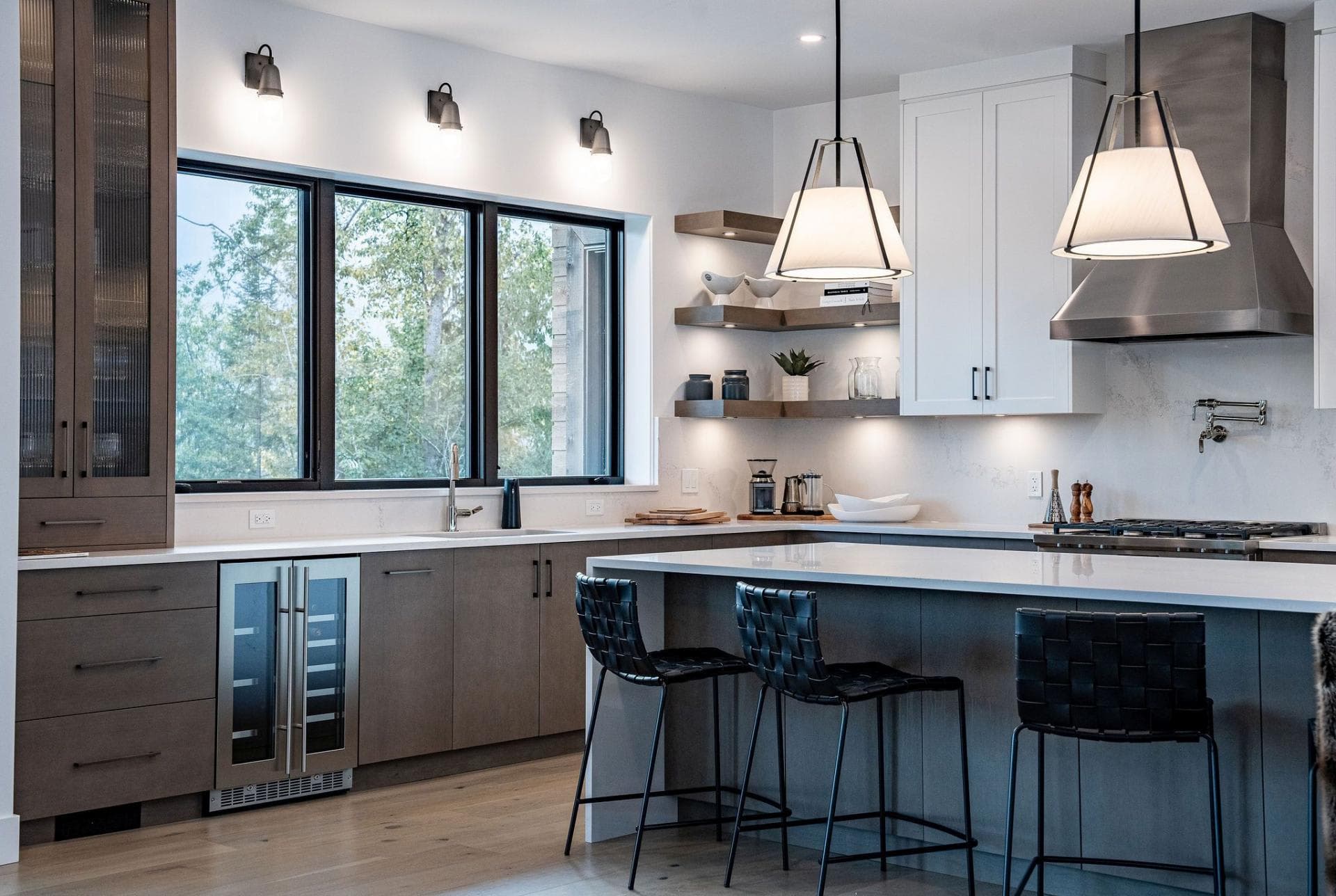 Kitchen with wine fridge, island seating, and wall-mounted pot filler