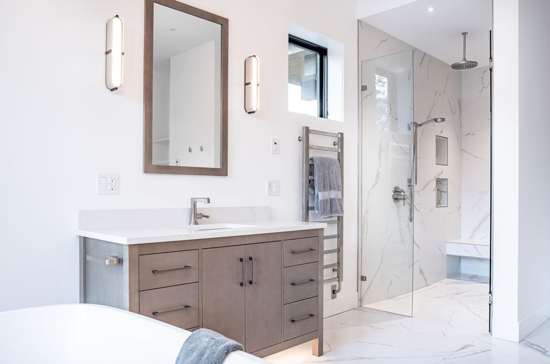 Bathroom with walk-in marble shower and heated towel rail