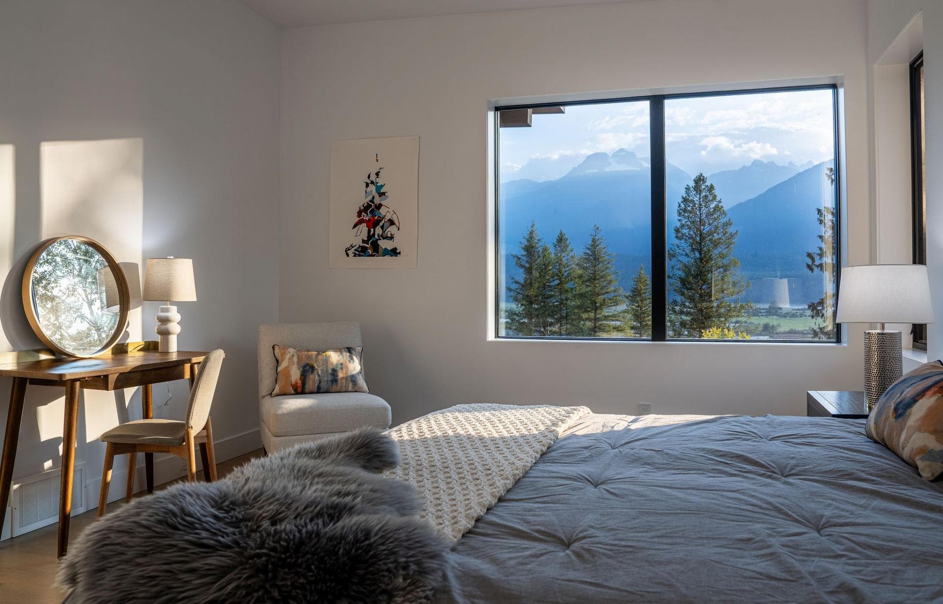 Bedroom with mountain views, dedicated workspace, and reading chair