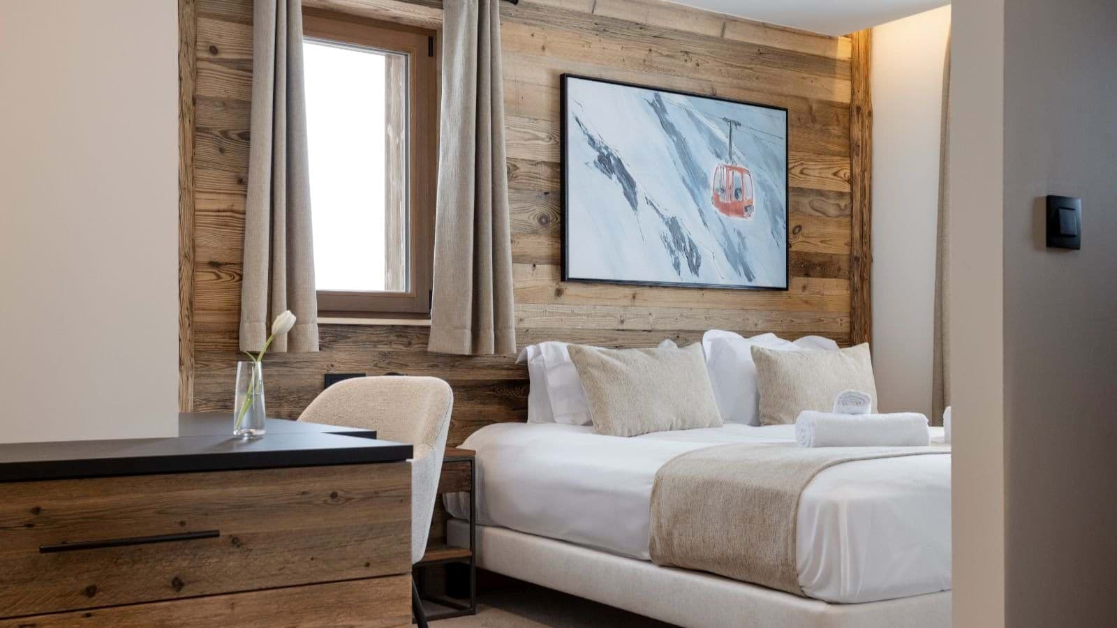 Bedroom with king bed and desk area; reclaimed timber walls