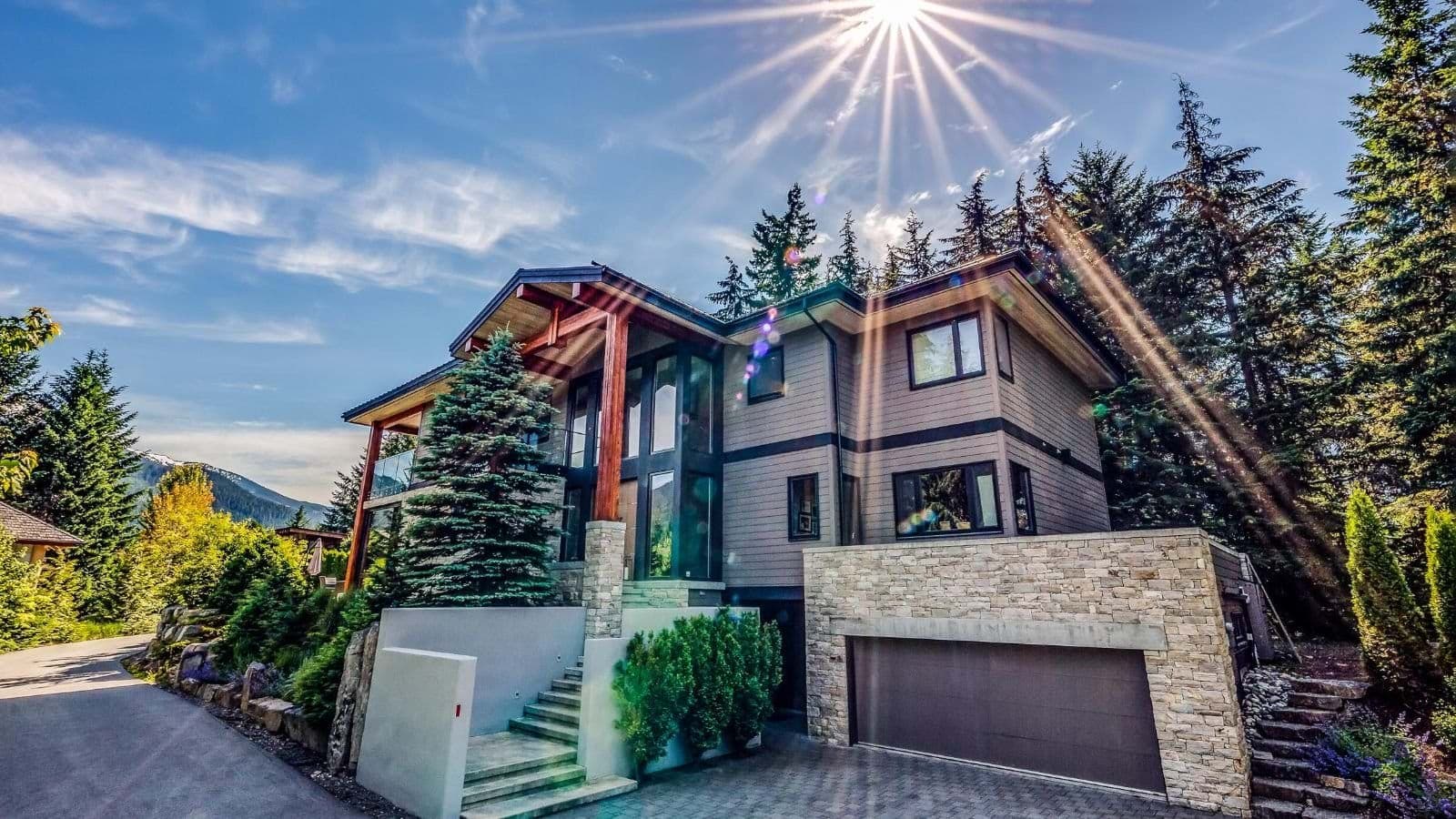 Property exterior featuring two-car garage and stone masonry accents
