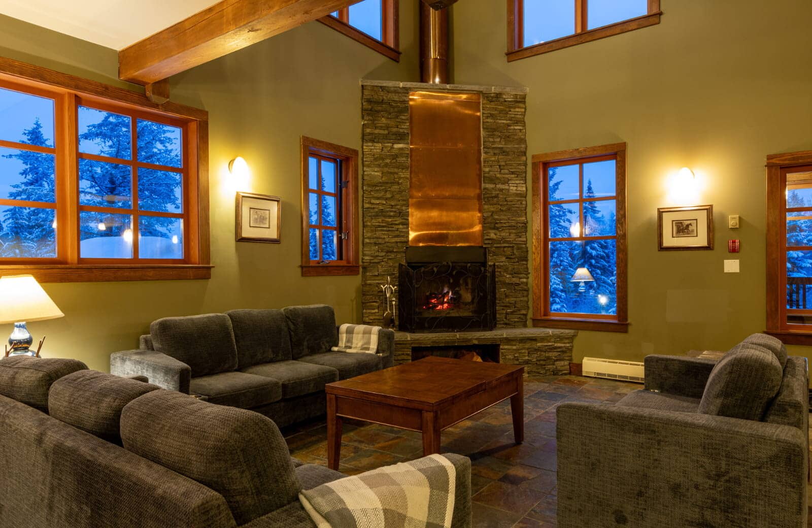 Living area with wood-burning fireplace and slate tile flooring
