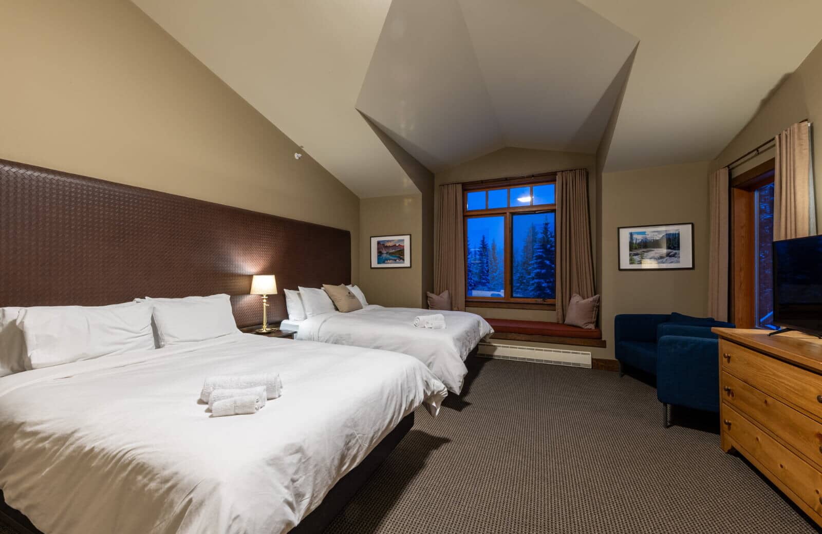 Guest bedroom with two queen beds and window seat