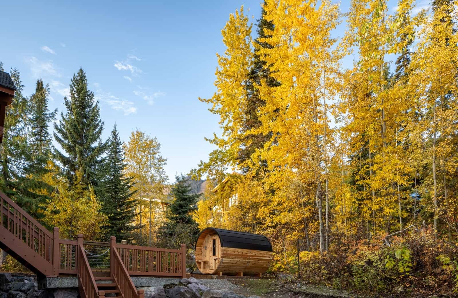 Cedar barrel sauna located on private deck with forest views