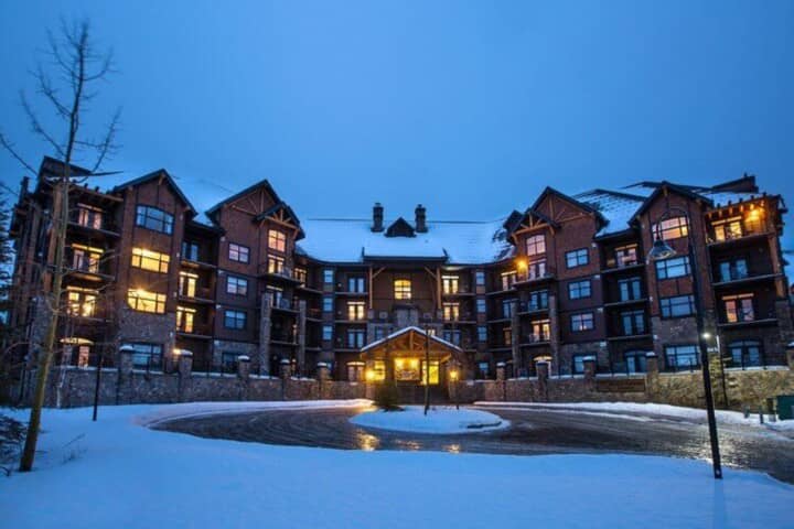 Ski-in lodge exterior with heated circular driveway and private balconies
