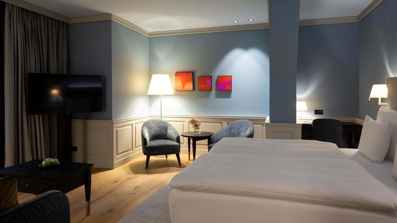 Primary bedroom with seating area and dedicated desk workspace