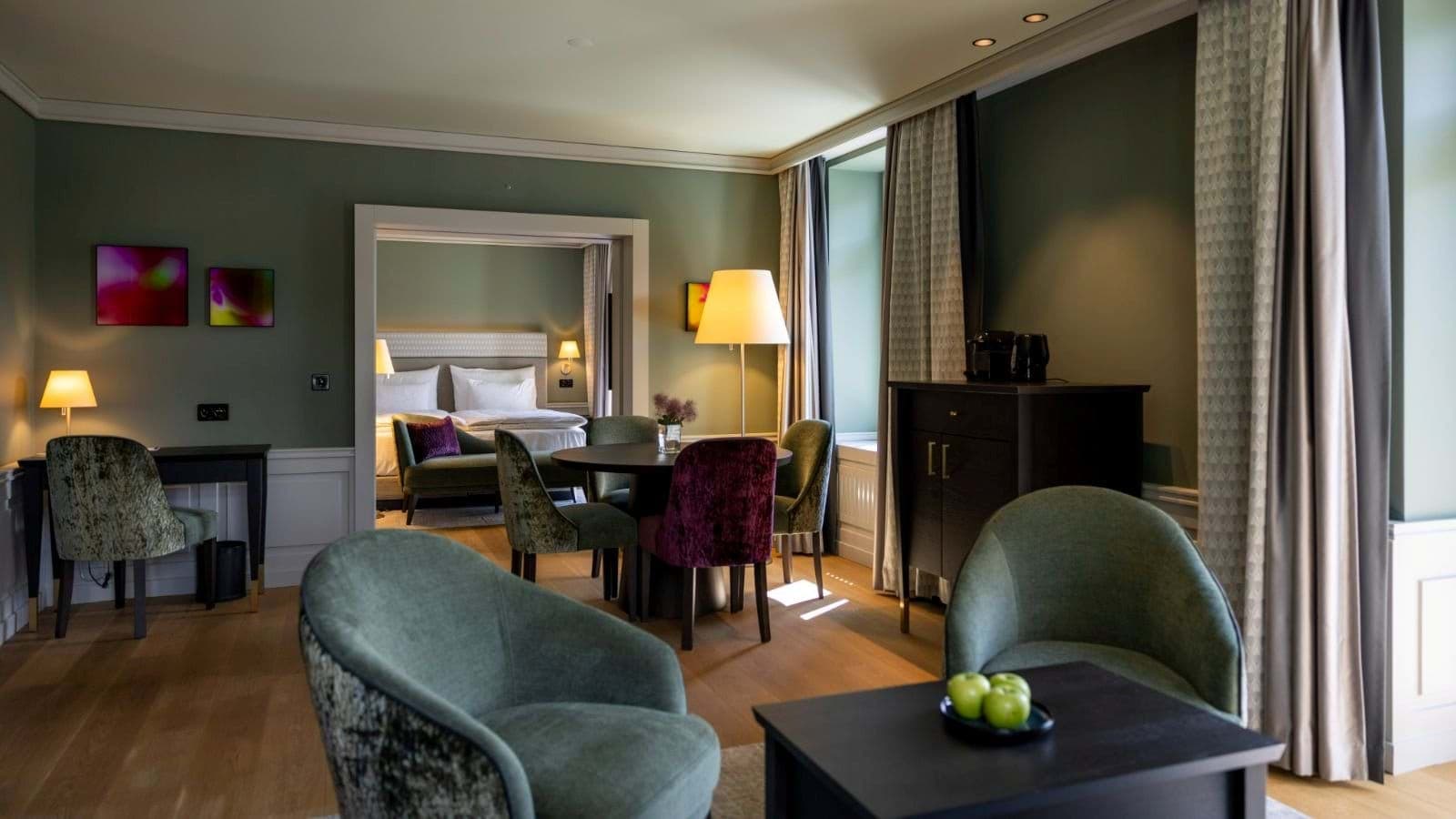 Suite living area with dining table, workspace, and coffee station