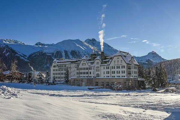 Historic hotel exterior with mountain views and snow-covered grounds