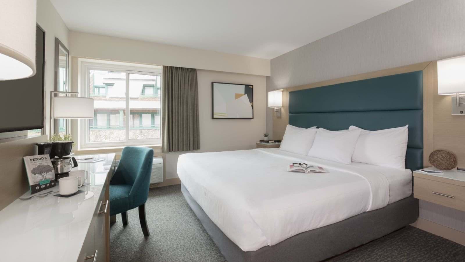 Guest bedroom with king bed and dedicated workspace with coffee station