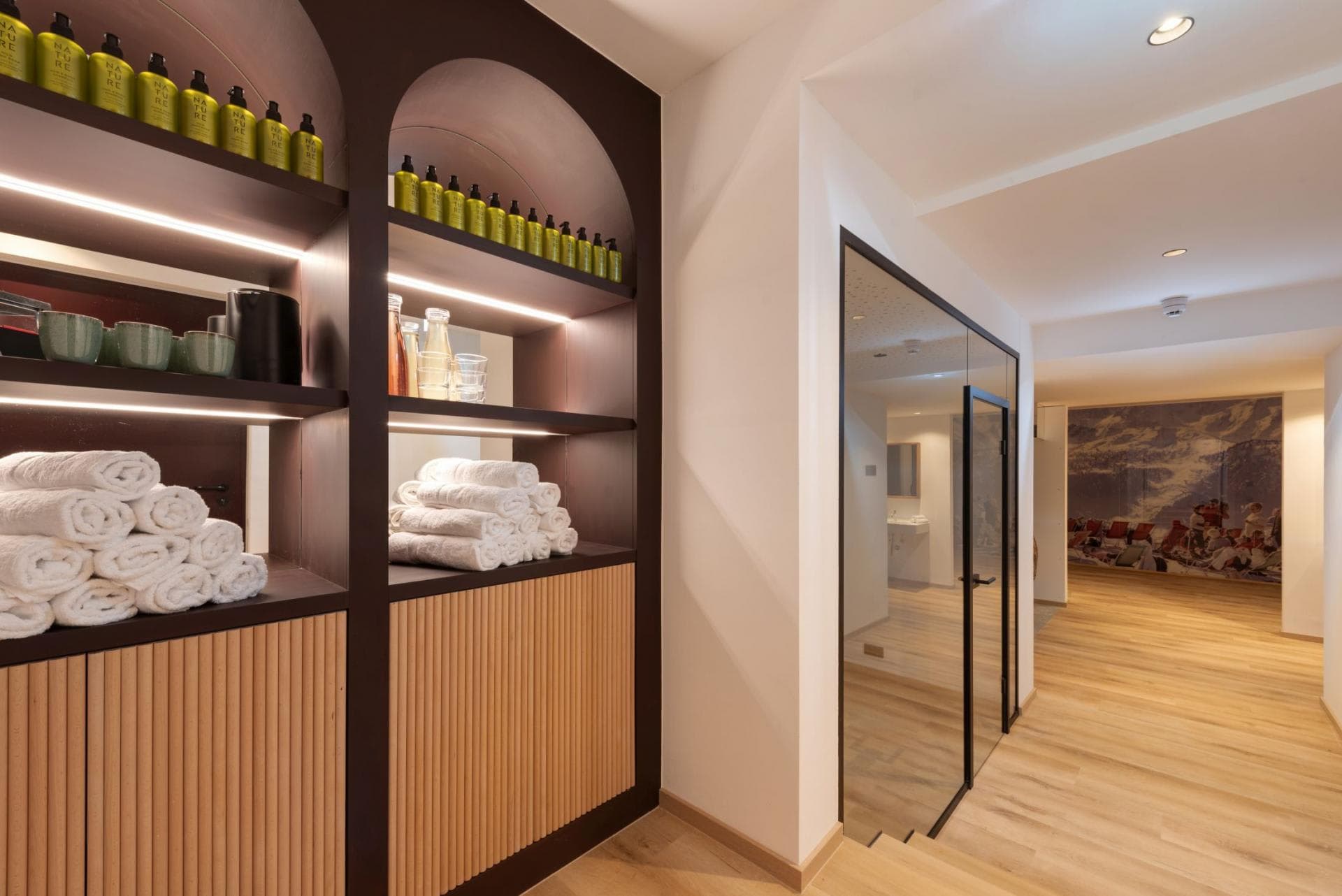 Spa entrance with complimentary toiletries, fresh towels, and glass-enclosed treatment room