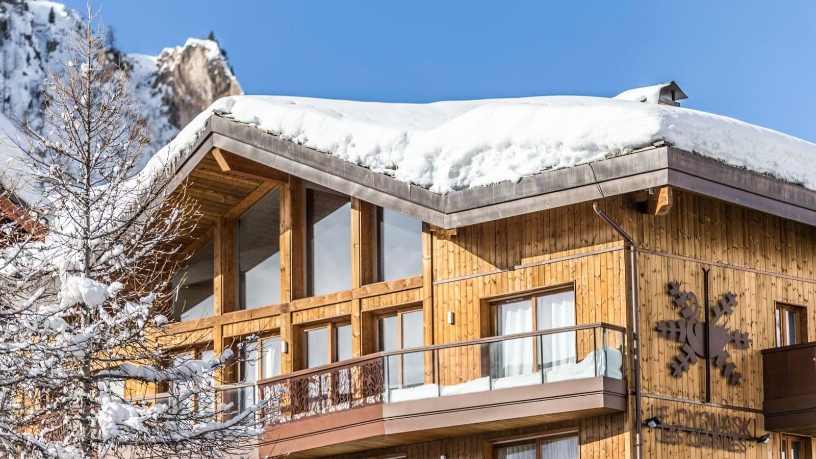 Chalet exterior with timber facade and private wrap-around balconies