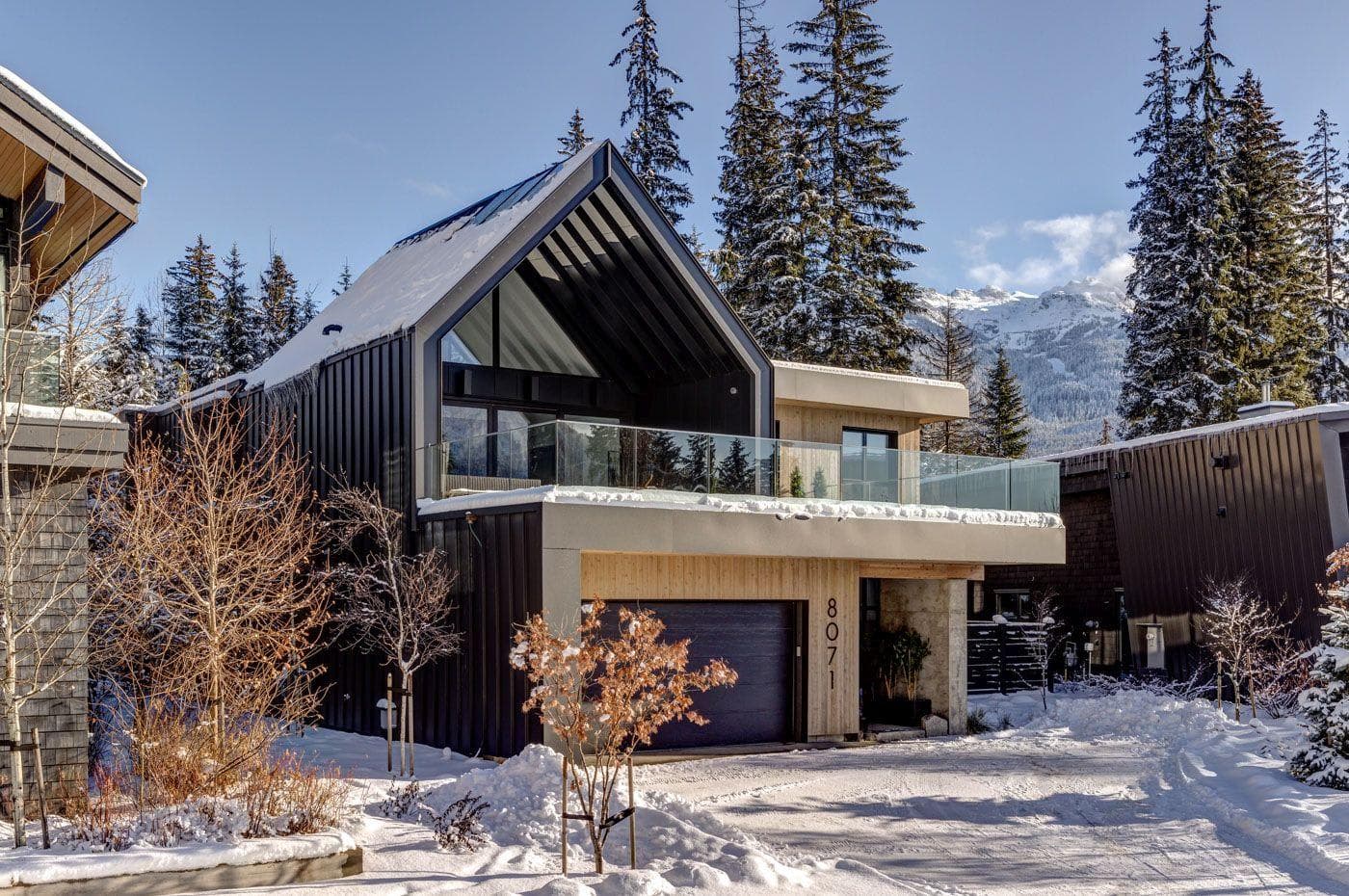 Chalet exterior with heated driveway, single garage, and mountain-facing balcony