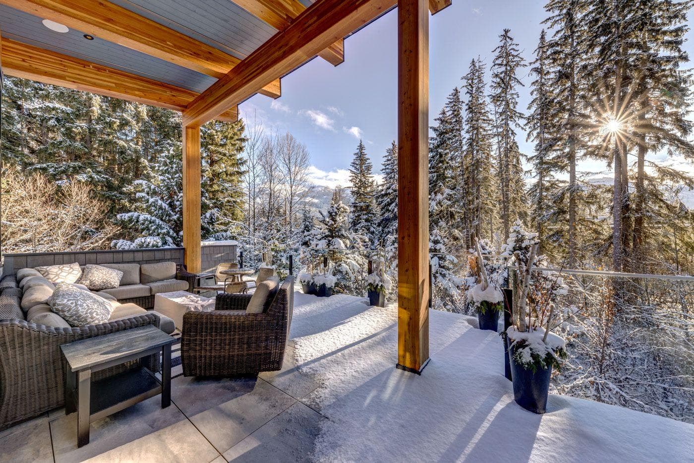 Covered outdoor deck with sectional seating and glass railings