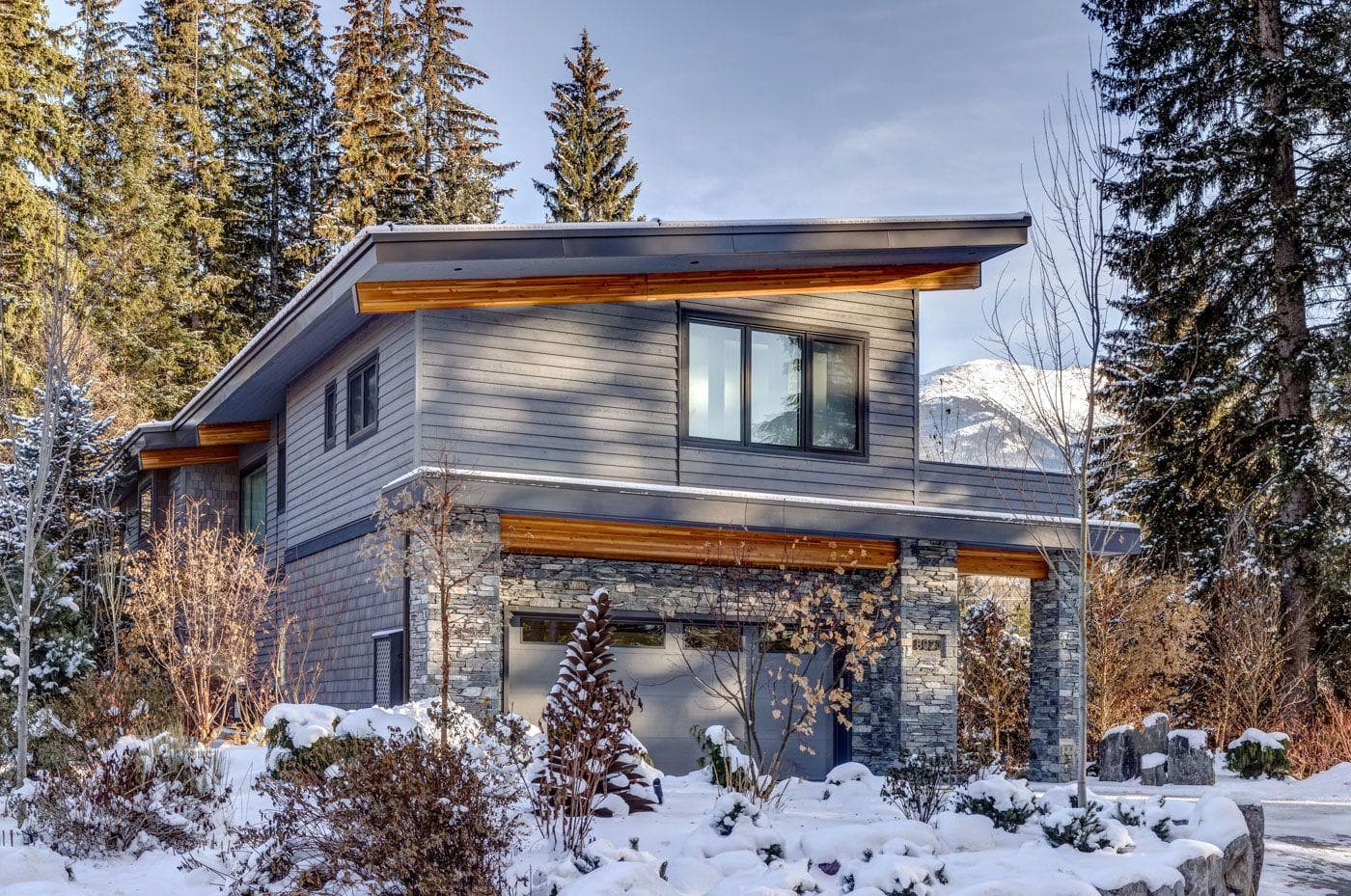 Alpine home exterior with 2-car garage and mountain views