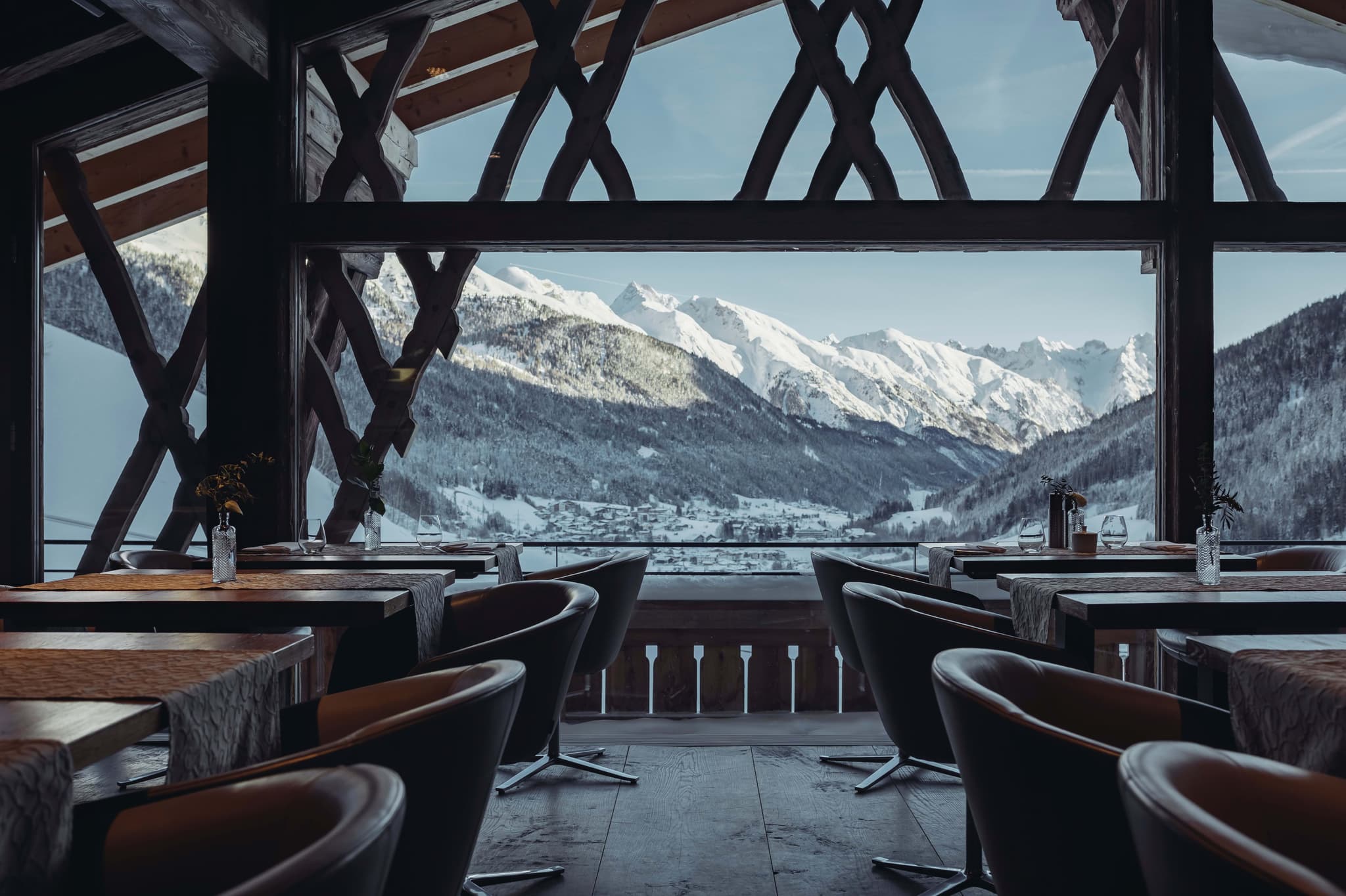 Dining area with timber accents and panoramic Alps valley views