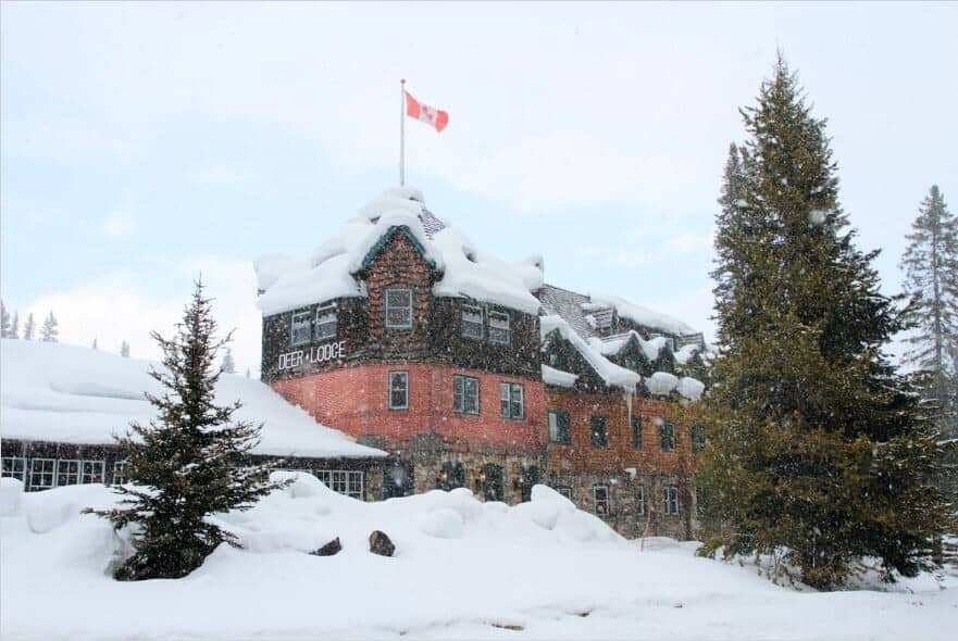 Deer Lodge exterior featuring hand-hewn log structure and stone masonry