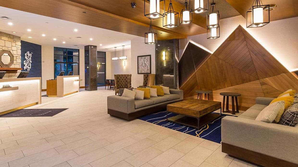Building lobby with 24-hour concierge desk and fireside lounge seating
