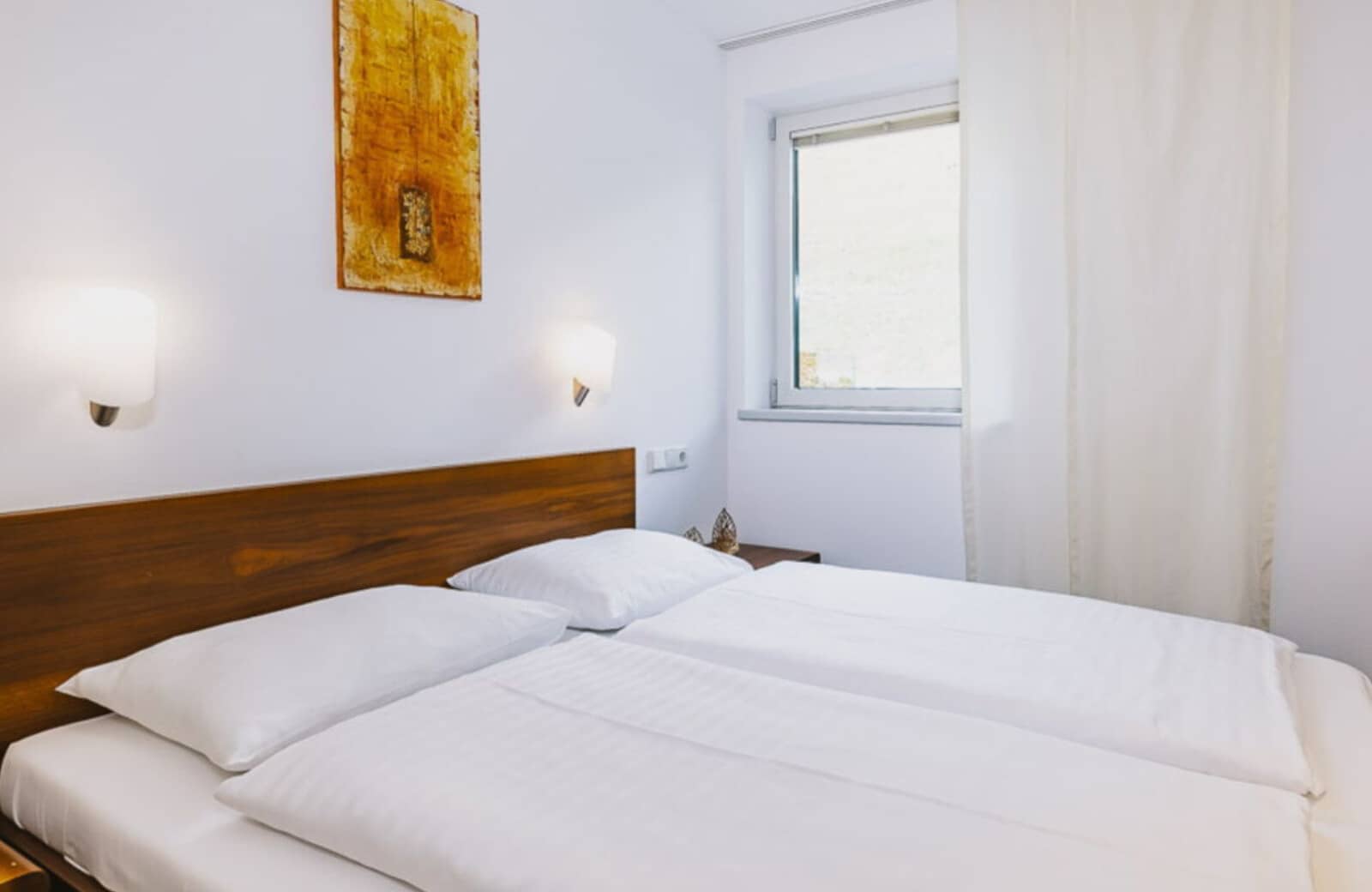 Guest bedroom with two twin beds and reading lights