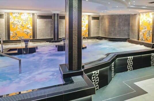 Indoor hydrotherapy pool with swan neck jets and massage stations