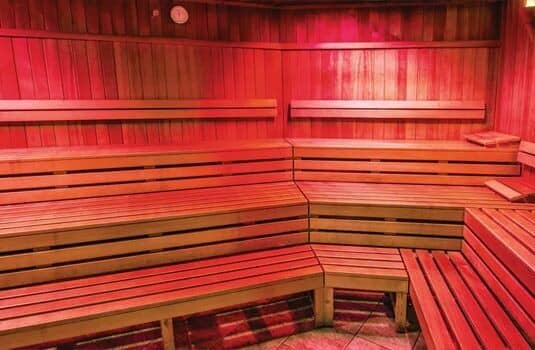 Cedar wood sauna with multi-level bench seating for 8