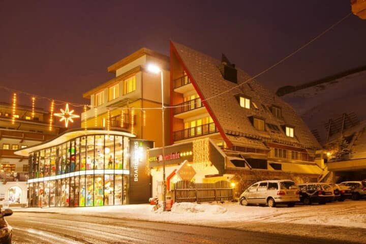 Hotel exterior featuring on-site ski shop and mountain-side location