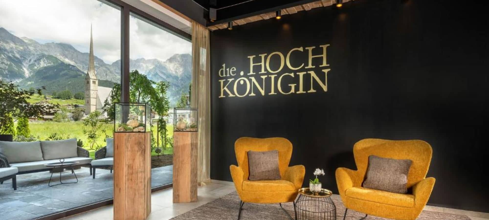 Lobby lounge with armchair seating and views of Maria Alm pilgrimage church